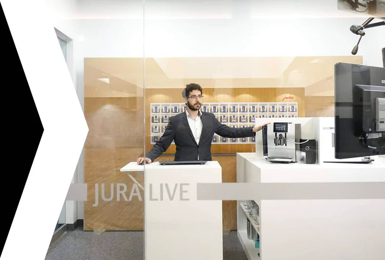 A Faema specialist demonstrating a Jura automatic coffee machine on camera in the Jura Live remote consultation studio